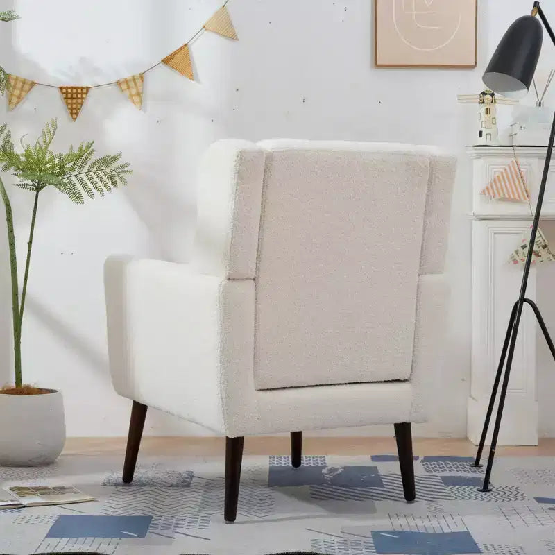 Poltroncina in ciniglia con schienale ergonomico, gambe affusolate in legno e cuscino decorativo, capacità 125 kg