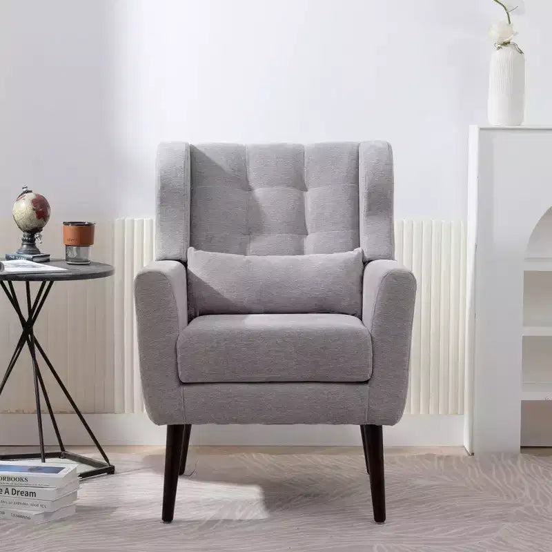 Poltroncina in ciniglia con schienale ergonomico, gambe affusolate in legno e cuscino decorativo, capacità 125 kg