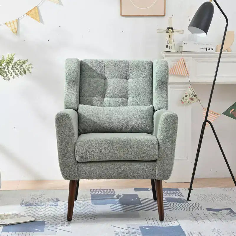 Poltroncina in ciniglia con schienale ergonomico, gambe affusolate in legno e cuscino decorativo, capacità 125 kg